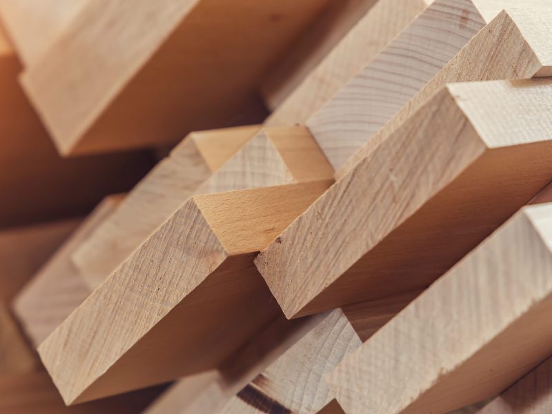 Wood timber construction material for background and texture. close up. Stack of wooden bars. small depth of field